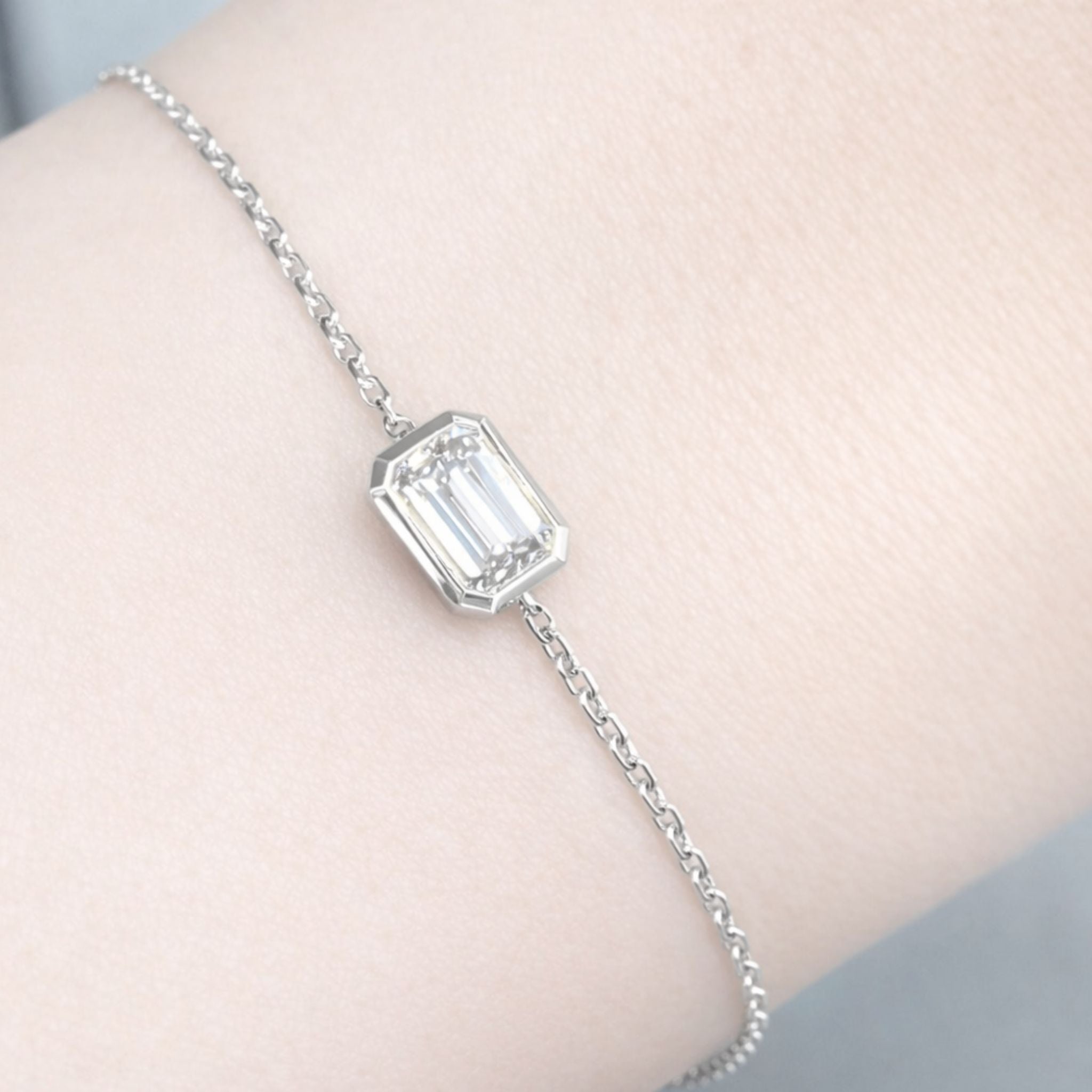 18K solid gold emerald-cut lab-grown diamond bezel bracelet on black mirror background