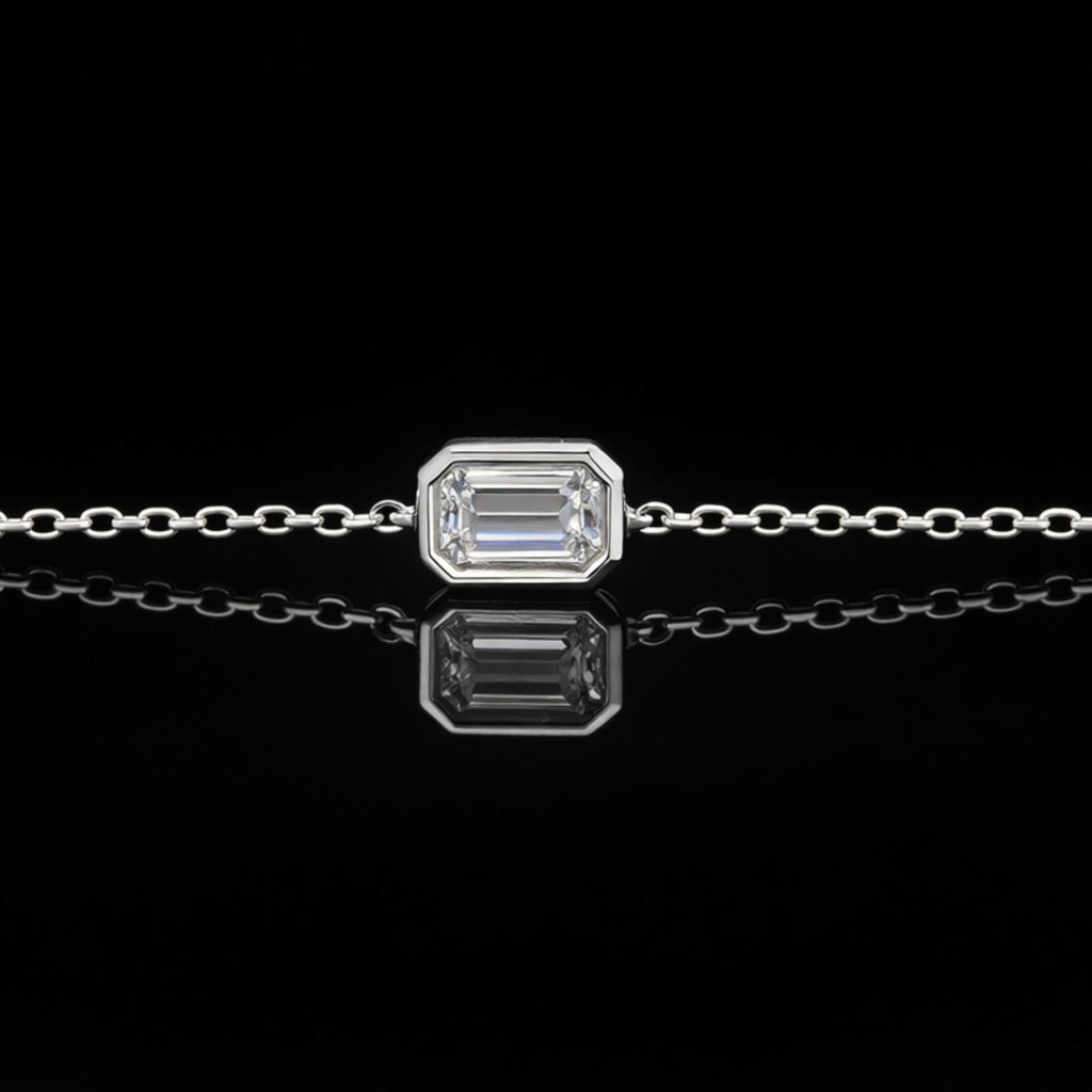 18K solid gold emerald-cut lab-grown diamond bezel bracelet on black mirror background