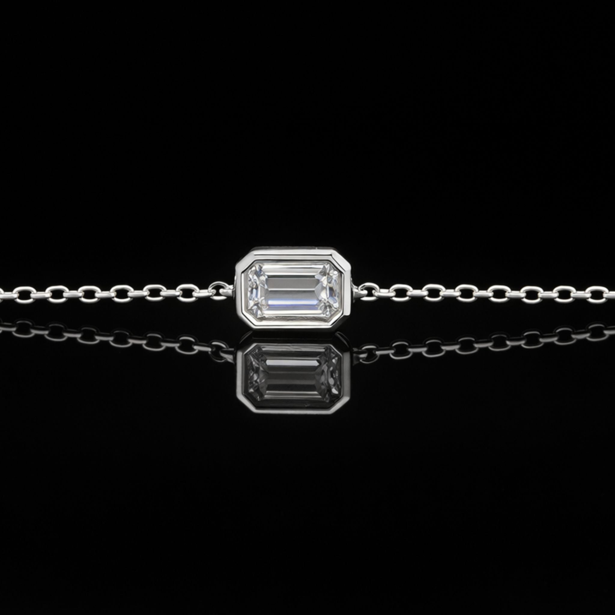 18K solid gold emerald-cut lab-grown diamond bezel bracelet on black mirror background